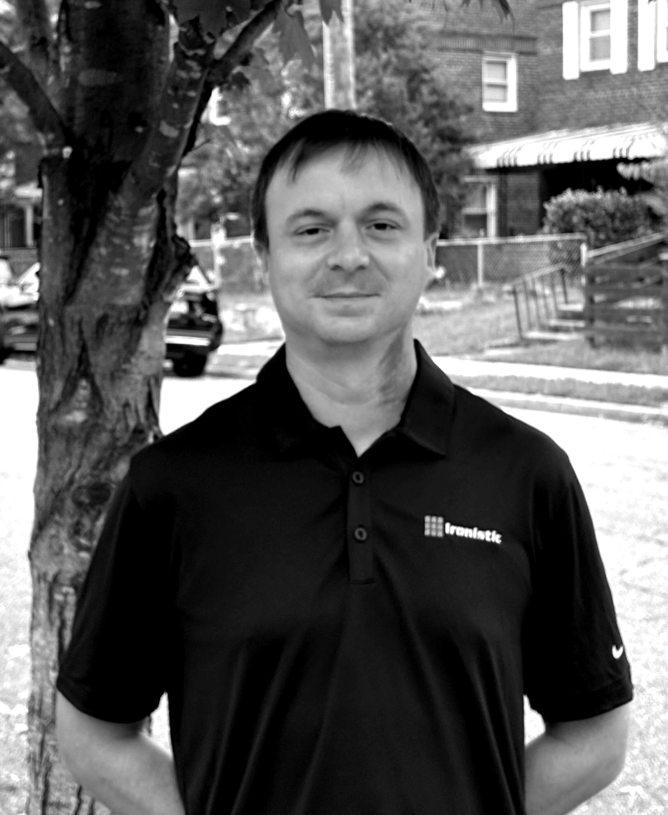 Black-and-white outdoor portrait of Ryan McGuire, Ironistic team member