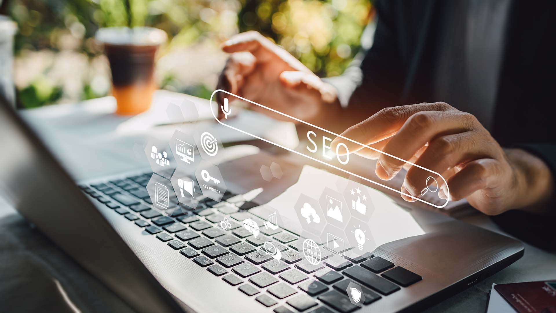 Person working on a laptop with SEO and search icons overlay