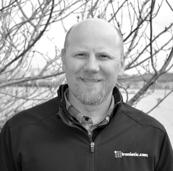 Professional black-and-white headshot of Jared Elliott, Ironistic team member