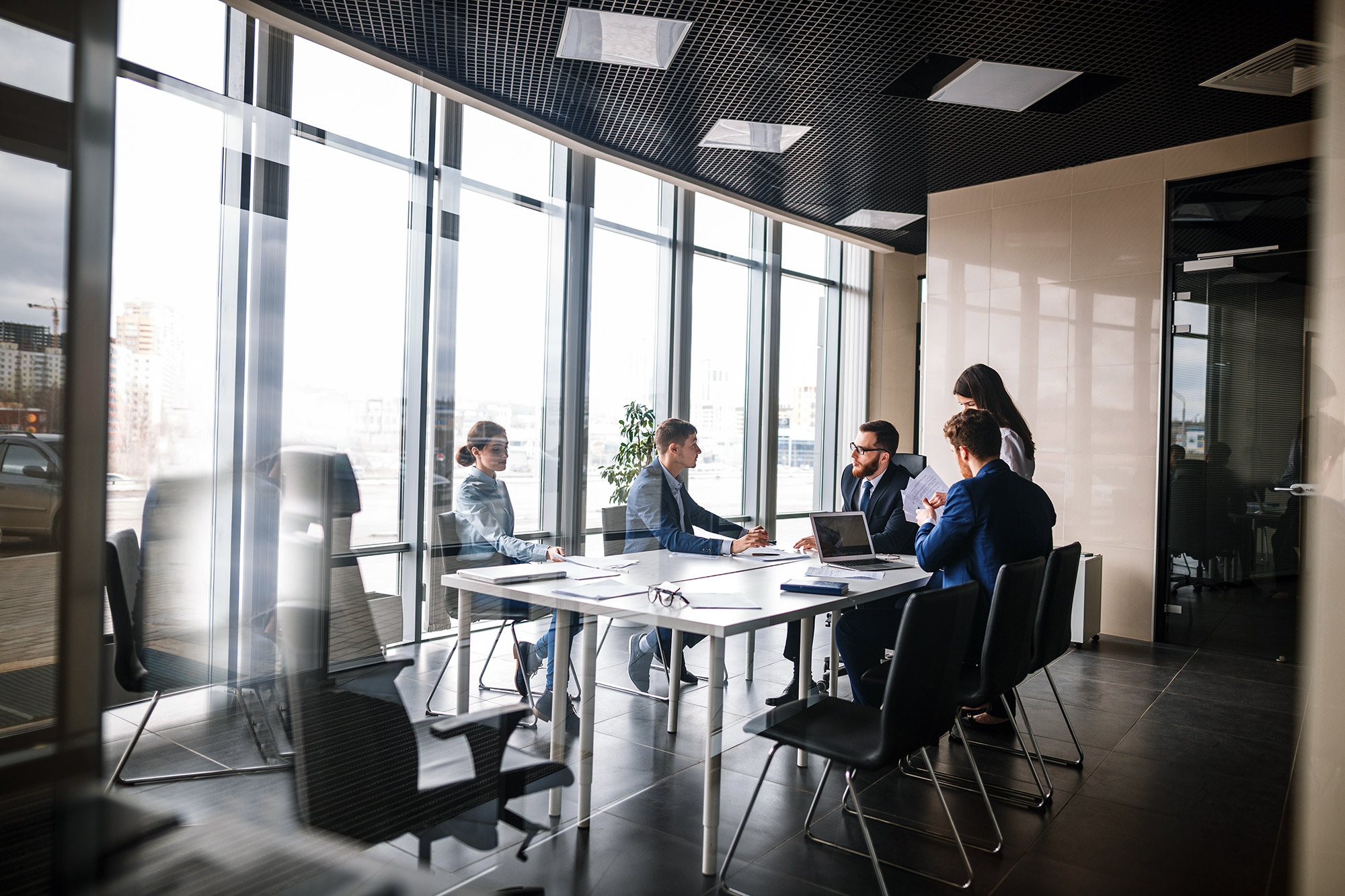 Team meeting in a modern glass-walled conference room