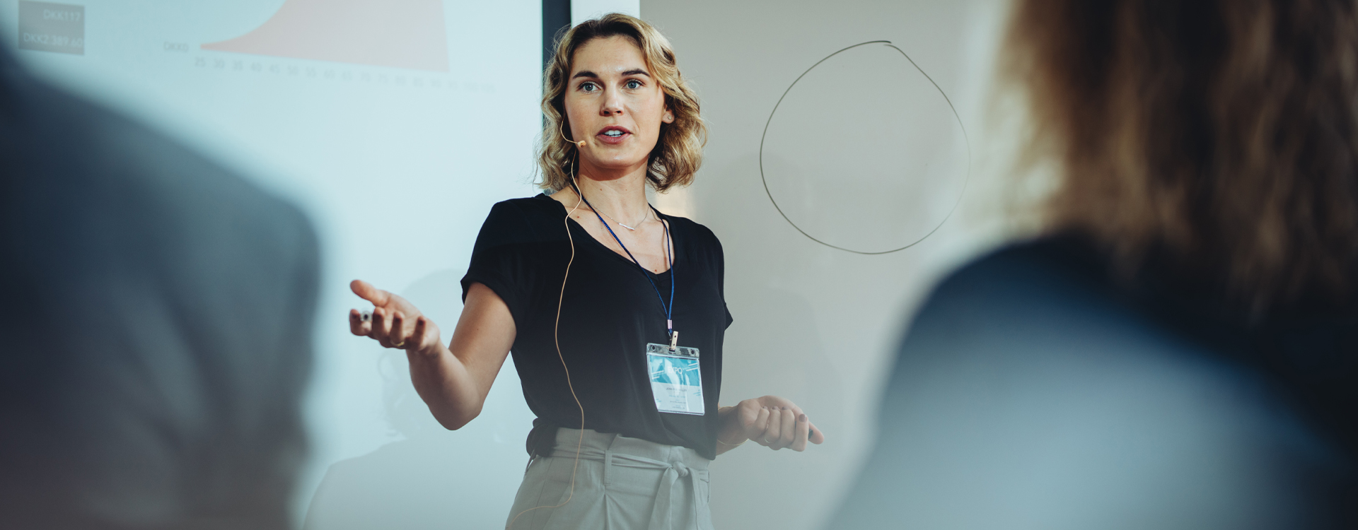 Woman presenting to an audience at a corporate event