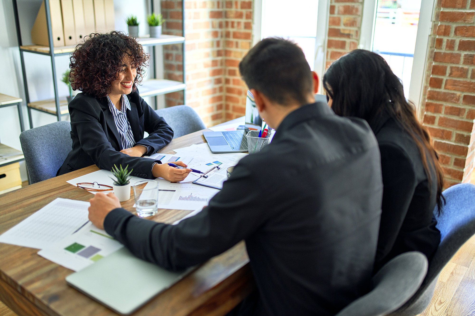 Customers meeting with a banker across a table