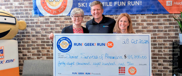 Ironistic team presenting a charity check at the run geek run 5k event - ironistic