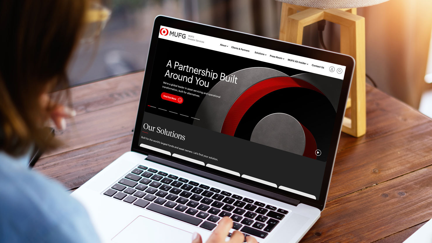 Mockup image of a woman using laptop with blank screen on wooden - ironistic Person viewing a corporate partnership website on a laptop - ironistic