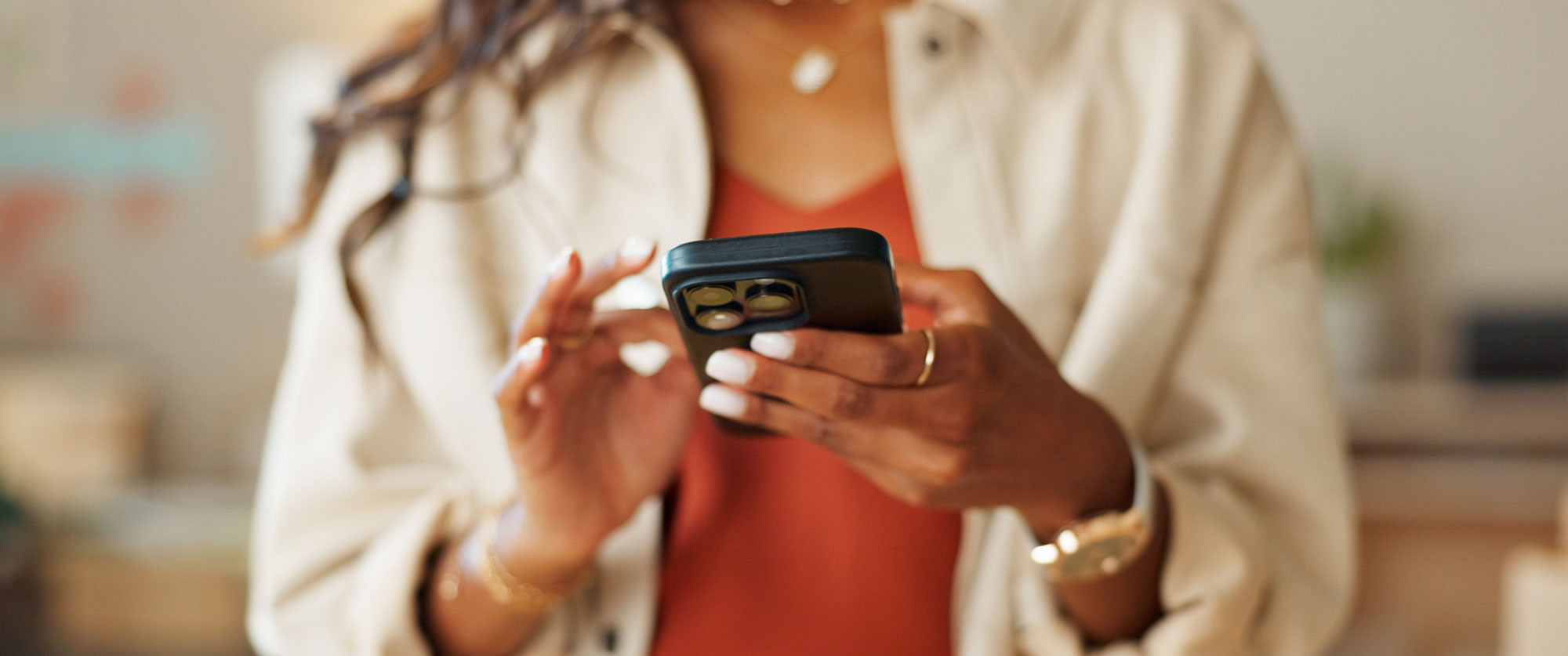 Woman using a smartphone, representing paid mobile advertising